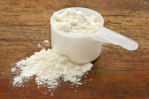 protein powder scoop on bench with protein powder